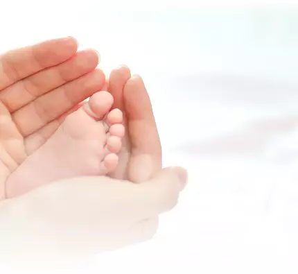 Baby’s feet in hands, symbolizing parenthood at Nova IVF Fertility Clinic in Bangalore